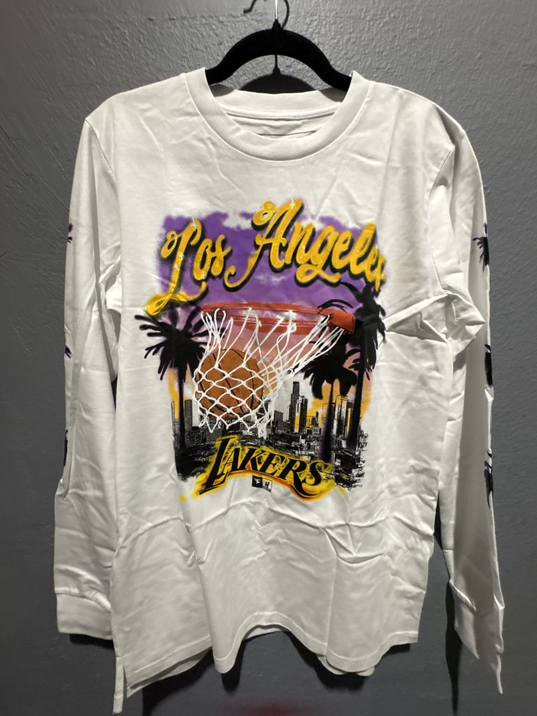 House of Highlights Los Angeles Lakers graphic long sleeve t-shirt in white showing the front skyline design and sleeve palm tree prints.
