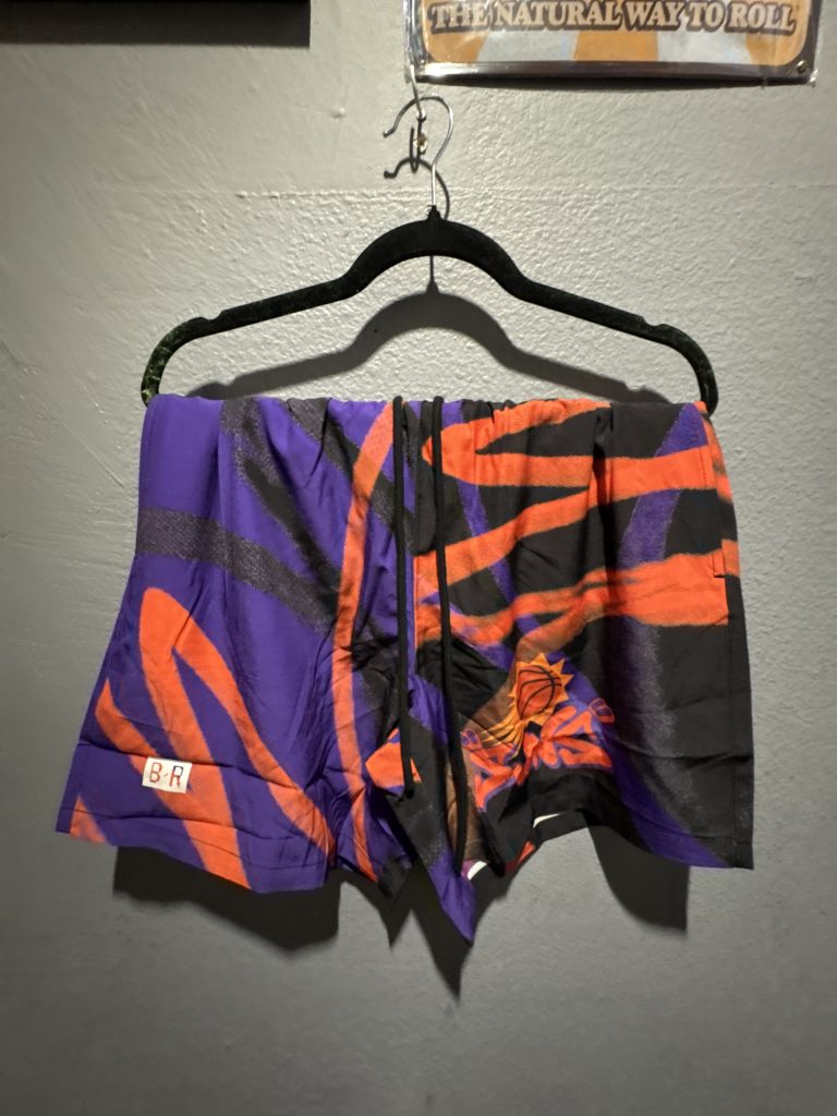 Bleacher Report Phoenix Suns graphic shorts in purple, orange, and black showing the abstract pattern, drawstring, and B/R hem label in size S.