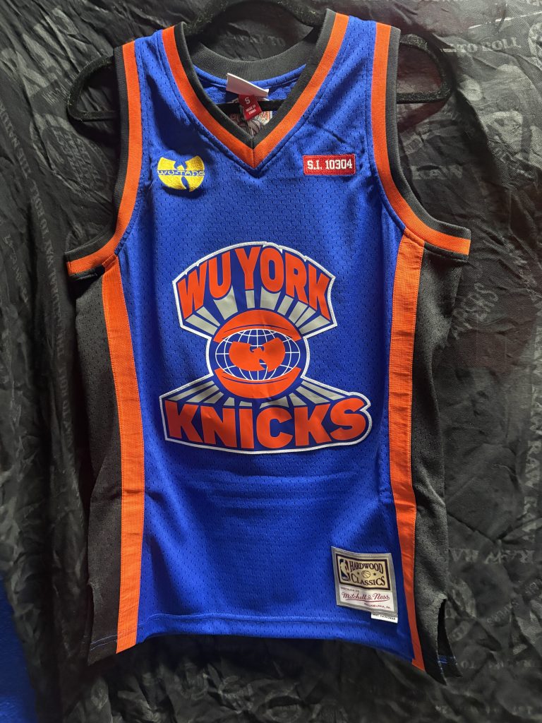 Wu-Tang Clan x Bleacher Report x Mitchell & Ness New York Knicks Remix Jersey in Blue showing the front Wu-York Knicks logo, Shaolin back, and size S tag.